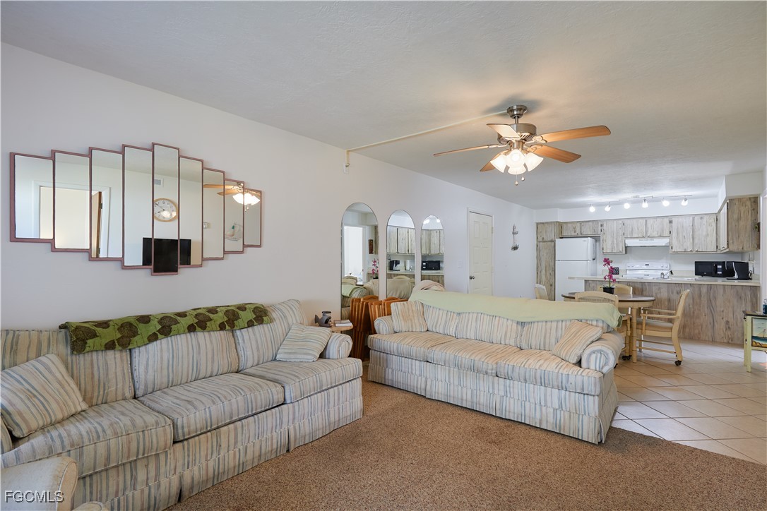 1100 Pondella Road, Unit 801 Cape Coral, FL 33909 - Photo 8 of 24 a view of living room with furniture and a chandelier