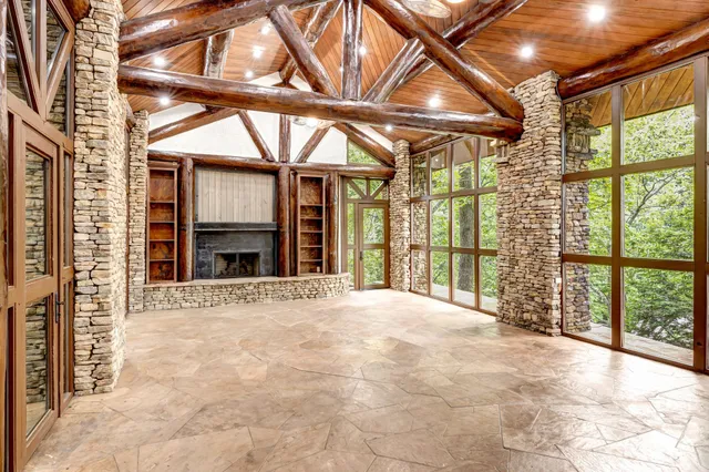 a view of a livingroom with a fireplace and window