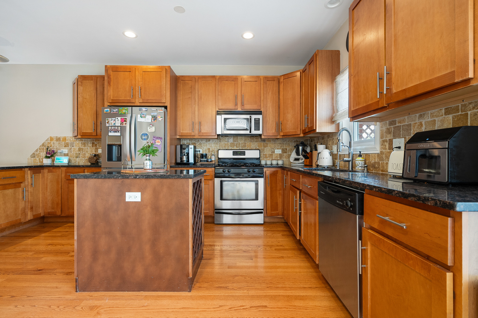 3638 North Odell Avenue Chicago, IL 60634 - Photo 11 of 46 a kitchen with stainless steel appliances granite countertop a stove a sink and a microwave