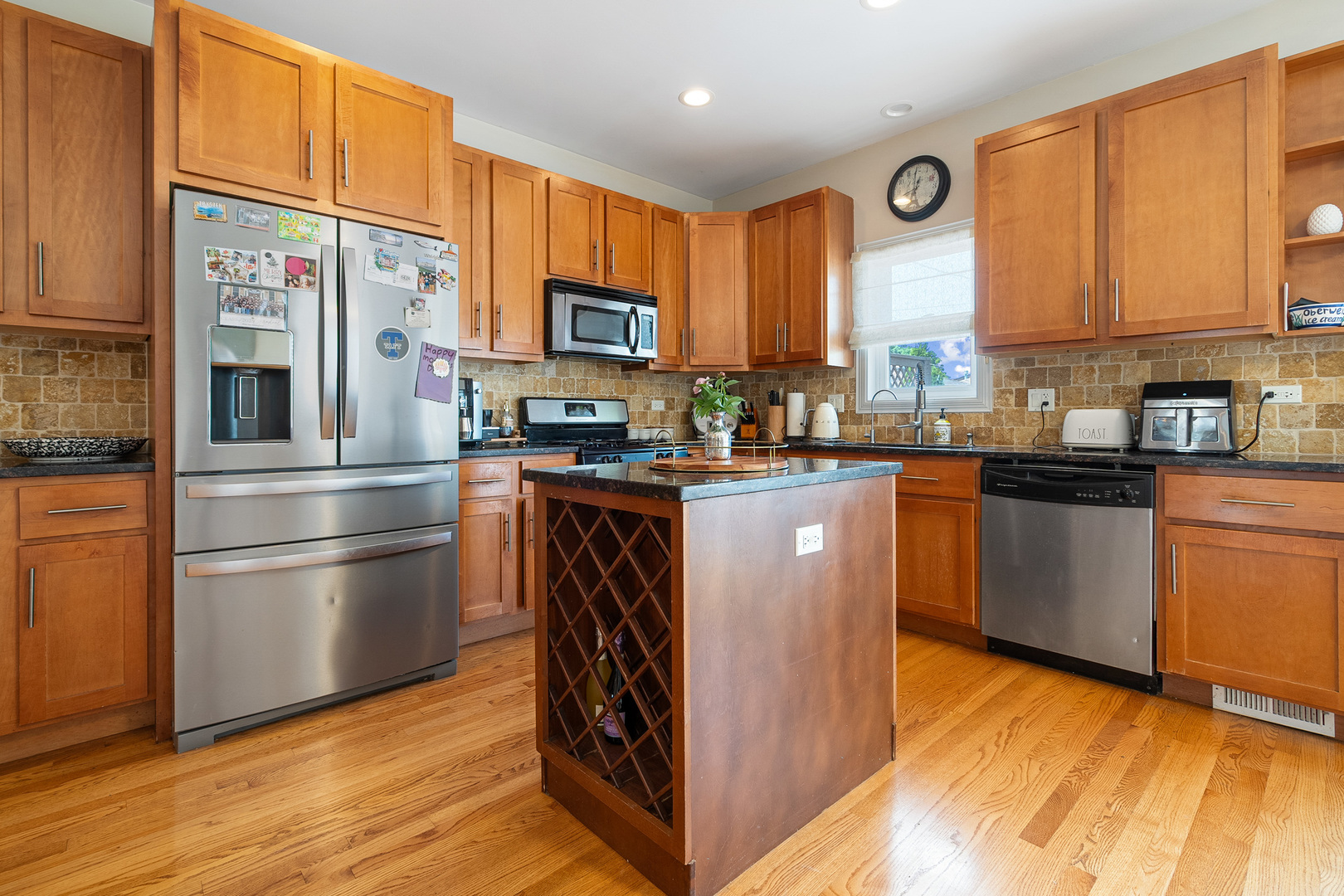 3638 North Odell Avenue Chicago, IL 60634 - Photo 12 of 46 a kitchen with stainless steel appliances granite countertop a stove a sink dishwasher a microwave oven and a refrigerator