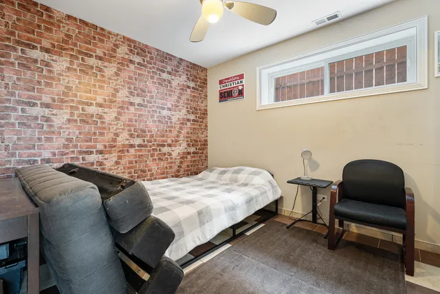 a bedroom with a bed and a chair