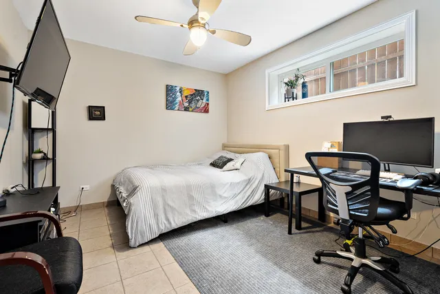 a bedroom with a bed and a desk