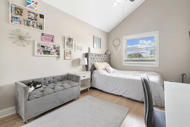a living room with furniture large window and wall painting