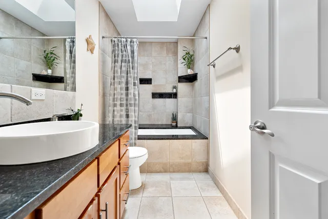 a bathroom with a tub a sink and a shower