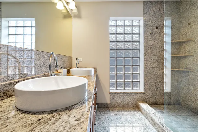a white bath tub sitting in a bathroom next to a window