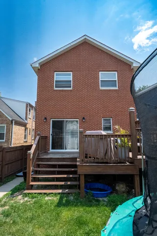 a view of backyard with deck and outdoor seating