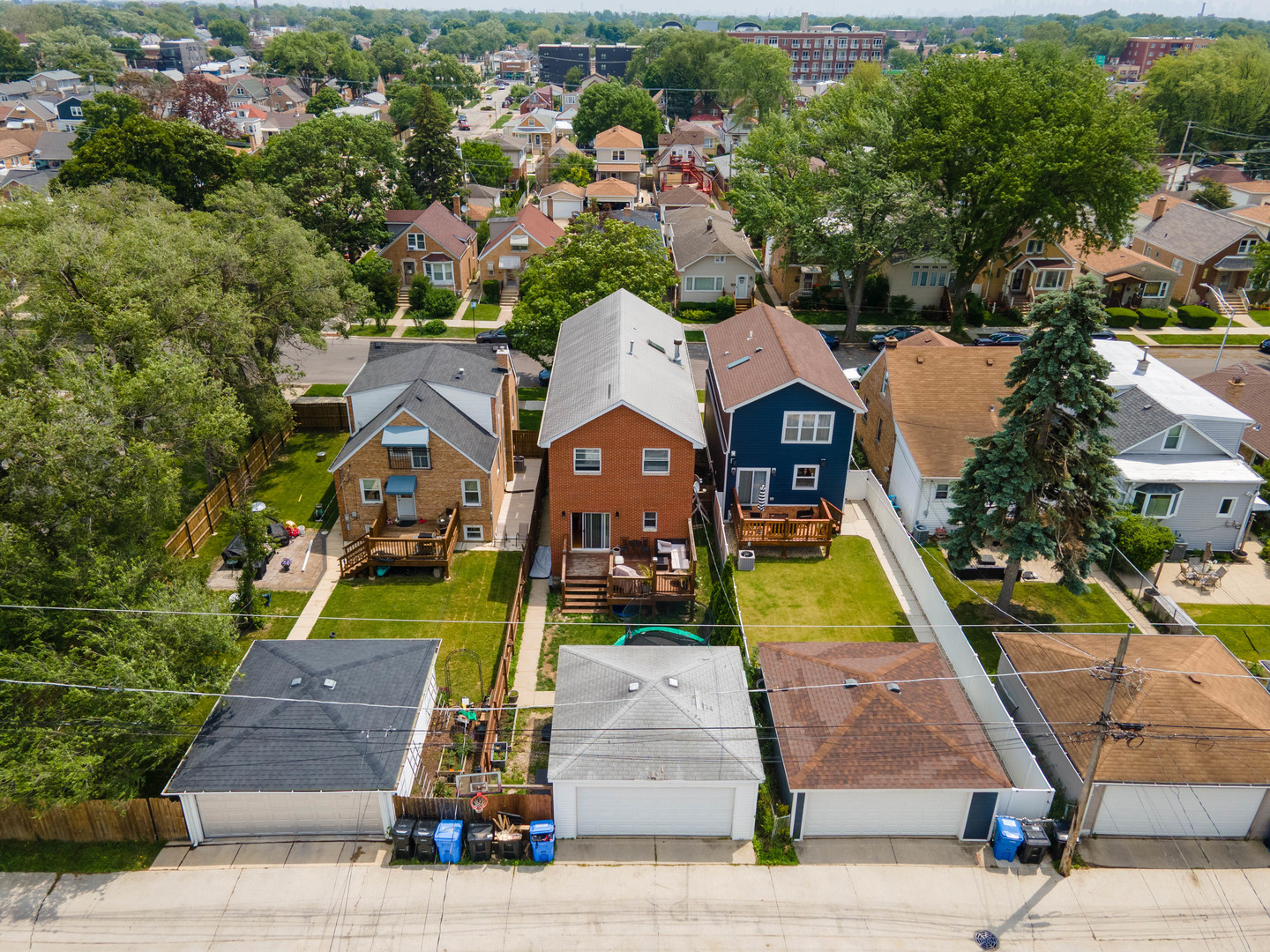 3638 North Odell Avenue Chicago, IL 60634 - Photo 41 of 46 an aerial view of a house with swimming pool and large trees