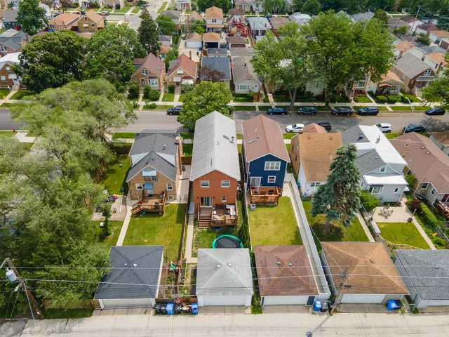 an aerial view of a house with a swimming pool