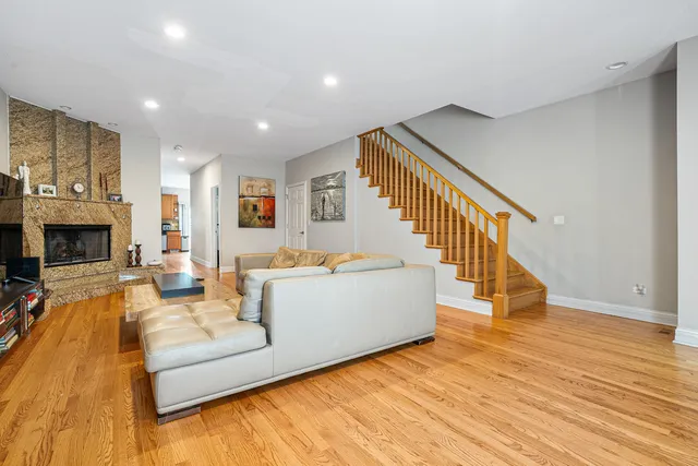a living room with fireplace furniture and a wooden floor