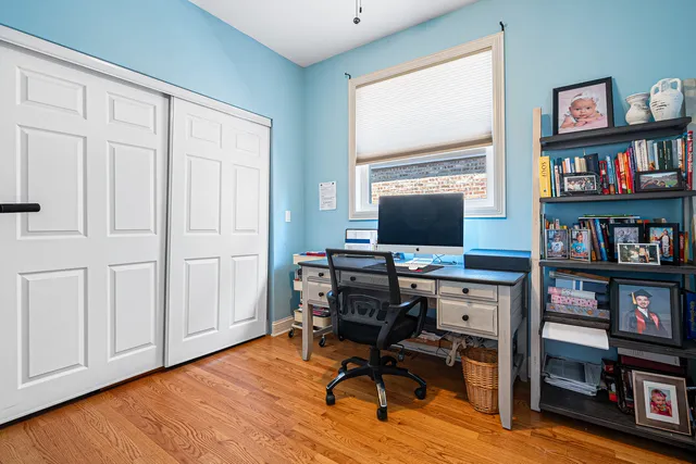 a view of a workspace with furniture and a bookshelf