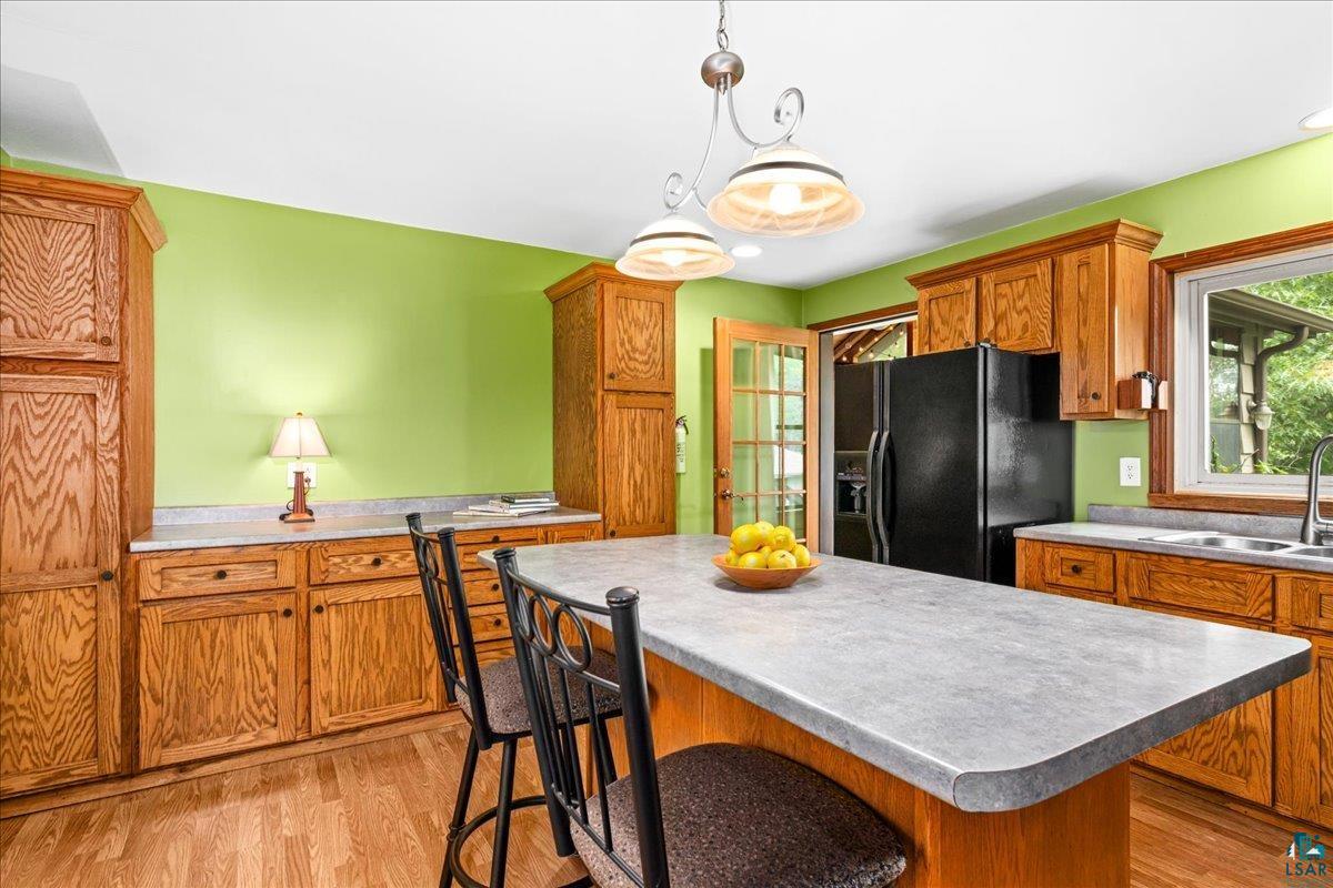 5195 Lavaque Junction Road Hermantown, MN 55811 - Photo 13 of 66 Kitchen featuring wood-finish cabinetry, light-toned countertops, and wood-finish flooring