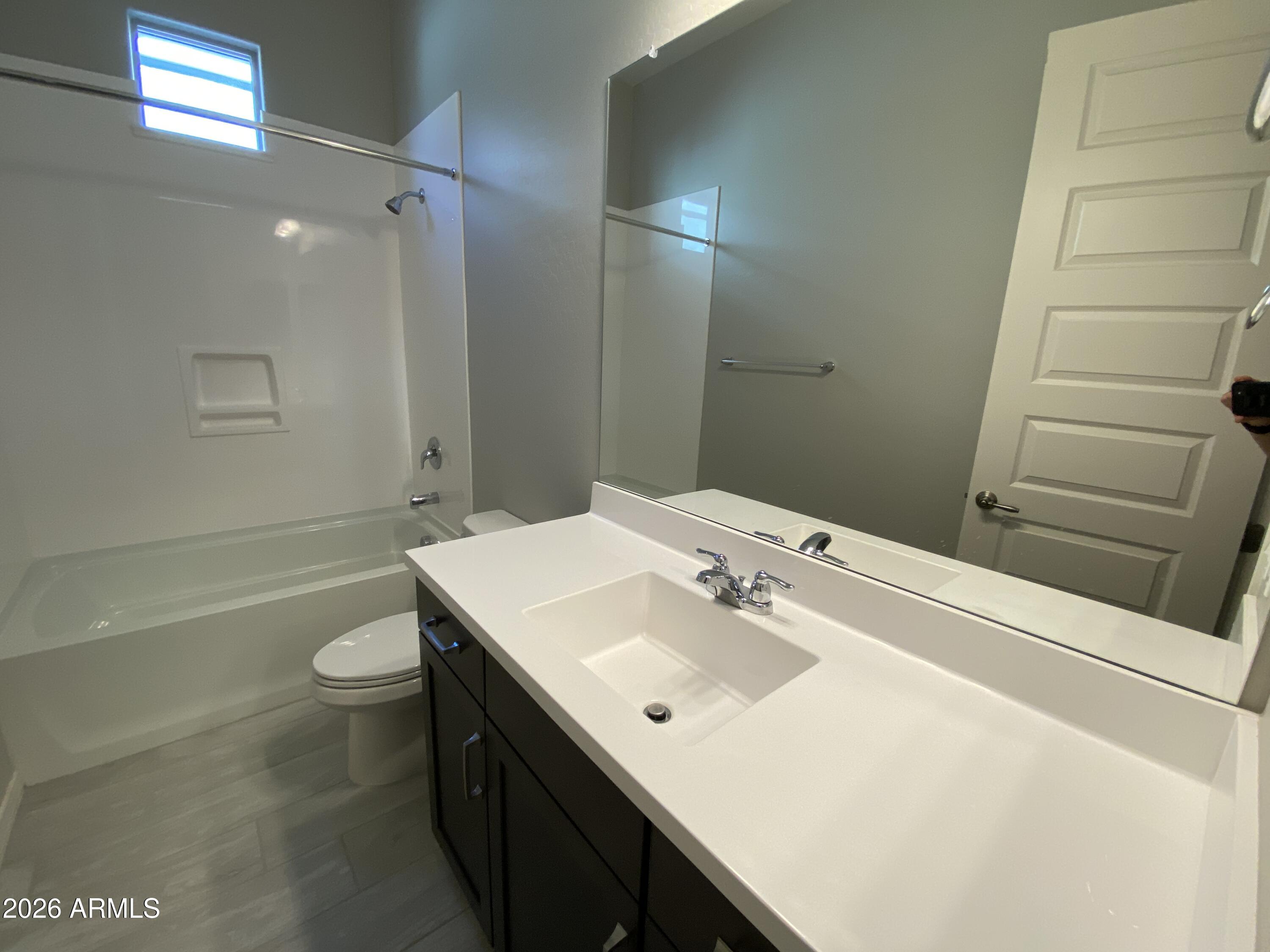 4150 East Bernice Street Gilbert, AZ 85295 - Photo 12 of 25 a bathroom with a sink a toilet and shower