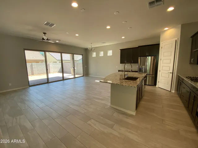 a kitchen with stainless steel appliances granite countertop a sink a stove and a refrigerator