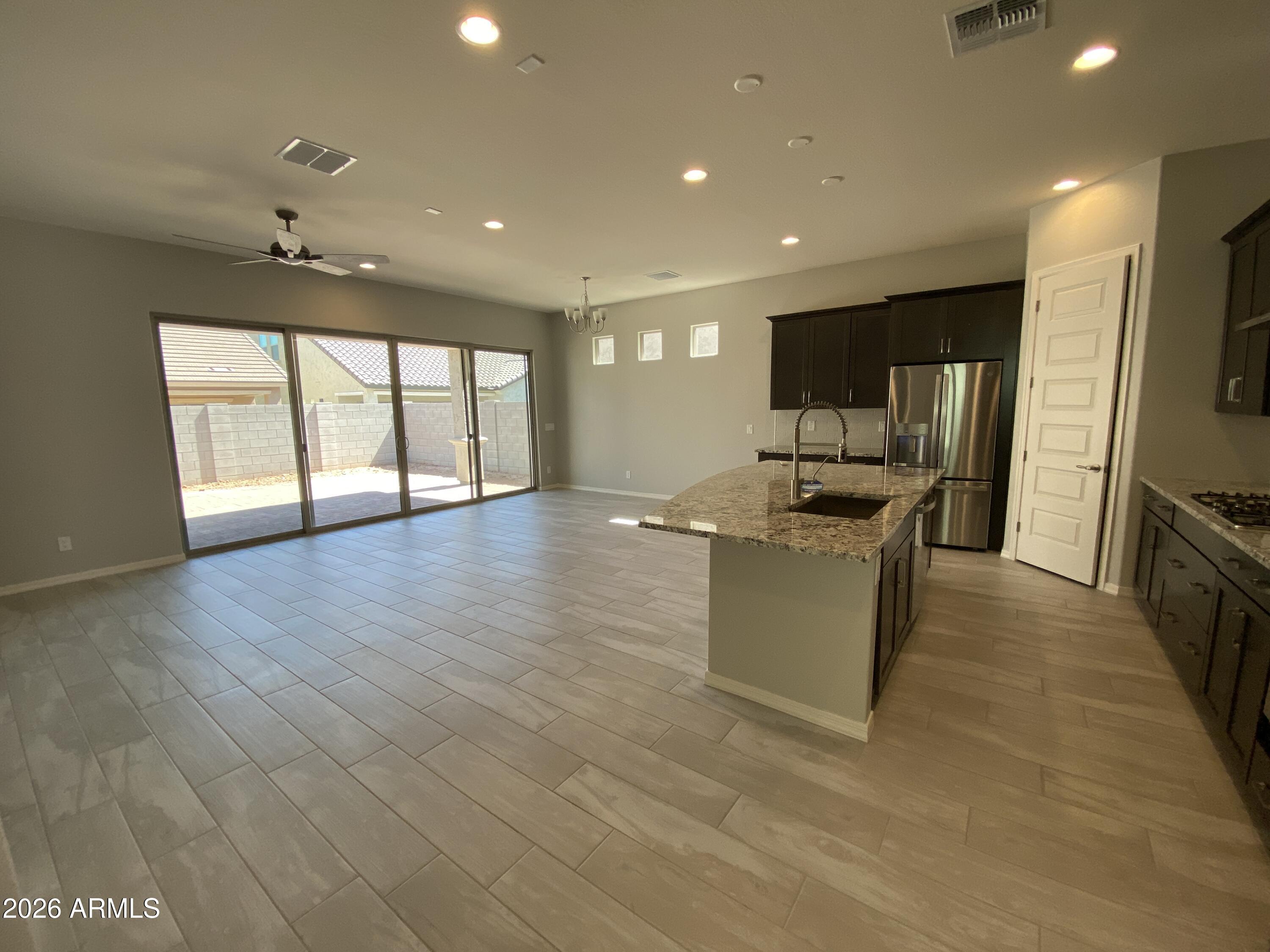 4150 East Bernice Street Gilbert, AZ 85295 - Photo 2 of 25 a kitchen with stainless steel appliances granite countertop a sink a stove and a refrigerator