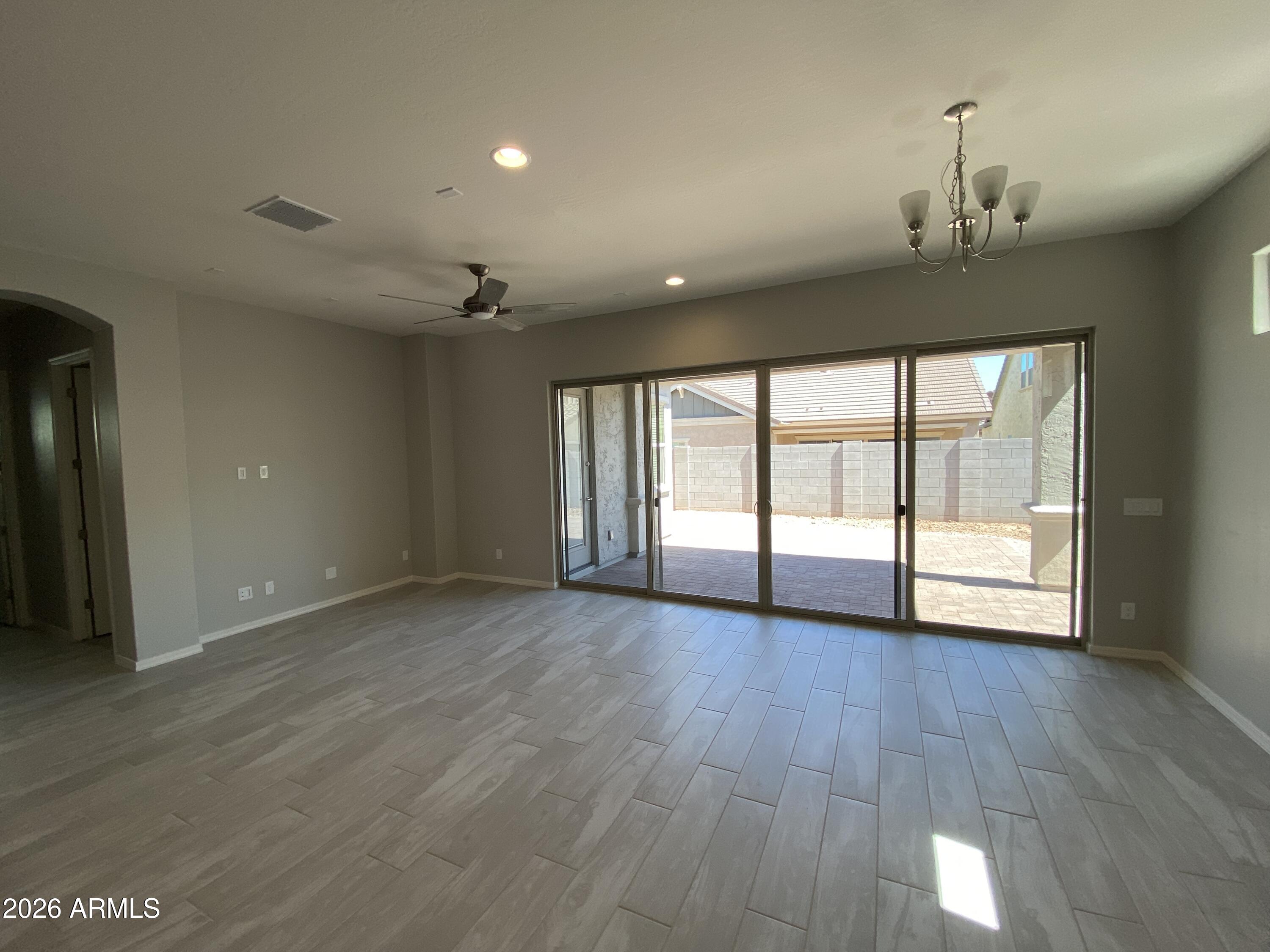 4150 East Bernice Street Gilbert, AZ 85295 - Photo 5 of 25 a view of an empty room with wooden floor and a window