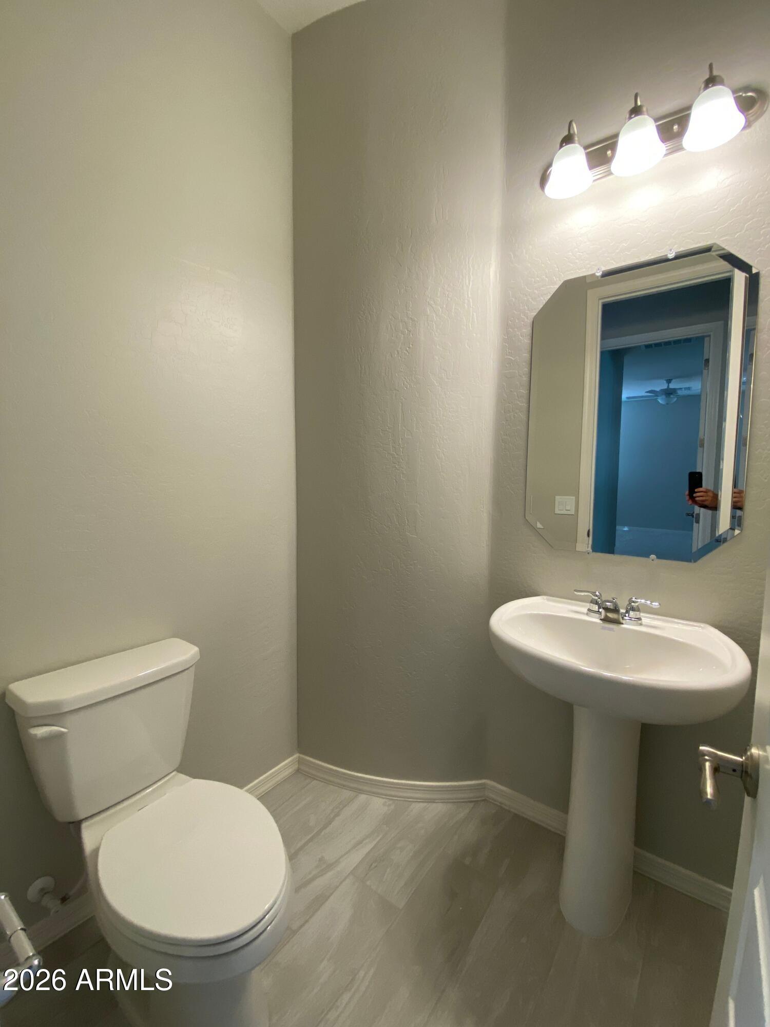 4150 East Bernice Street Gilbert, AZ 85295 - Photo 9 of 25 a bathroom with a toilet sink and mirror