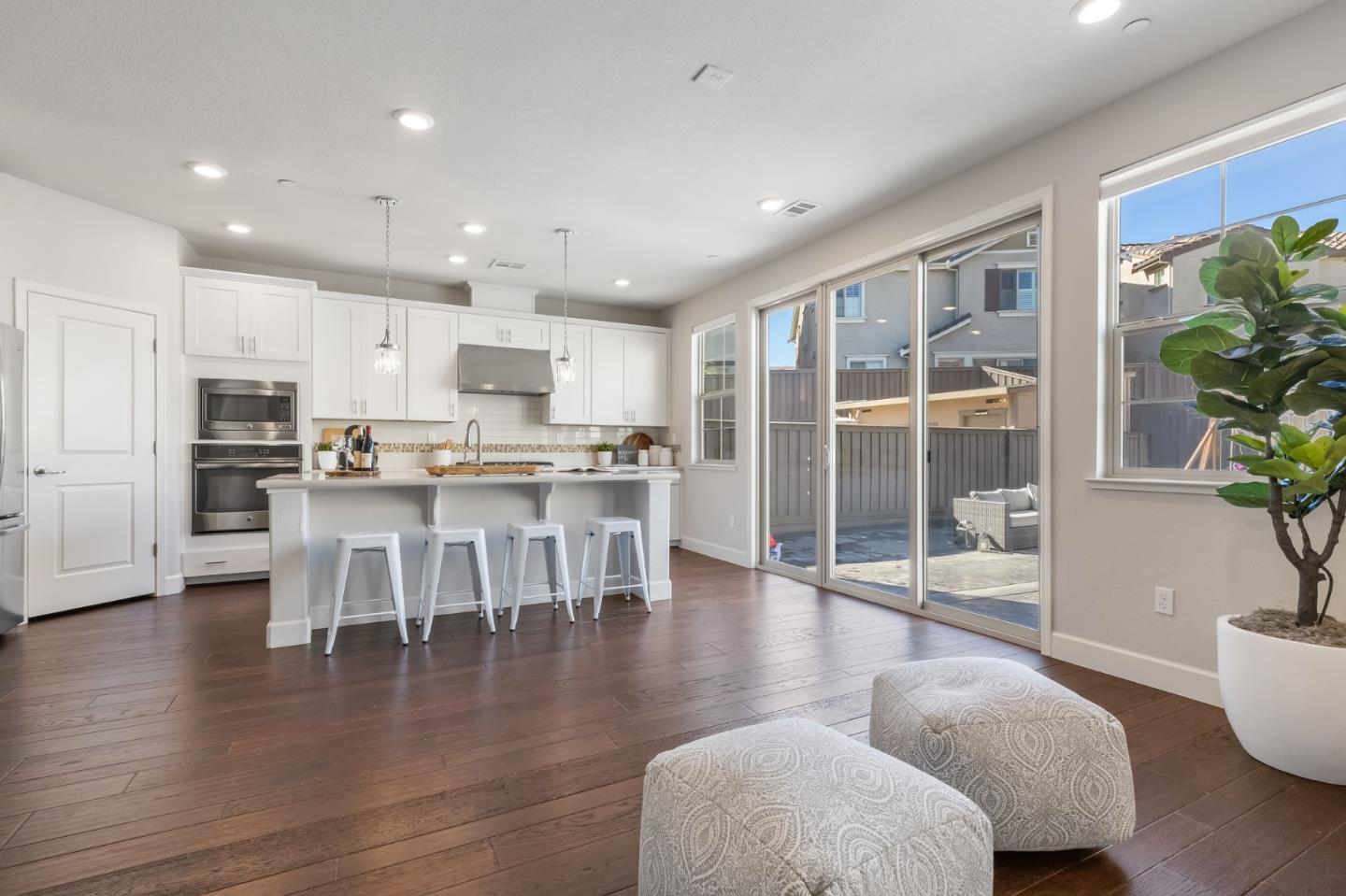 261 Crestview Circle Daly City, CA 94015 - Photo 13 of 45 a kitchen with stainless steel appliances granite countertop a stove a refrigerator a dining table and chairs with wooden floor