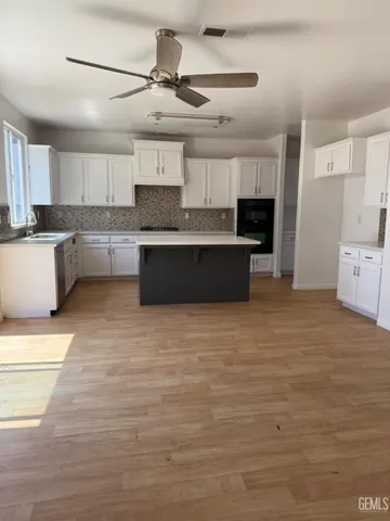 a view of an house with backyard space and balcony