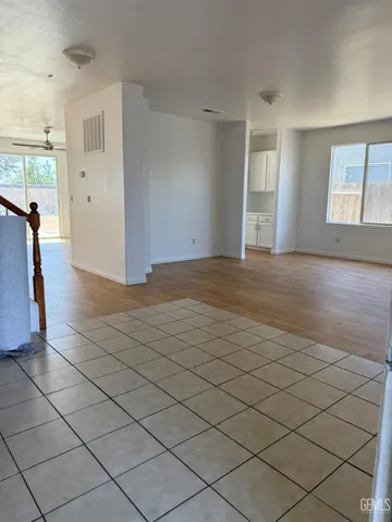 a view of a livingroom with wooden floor and a window