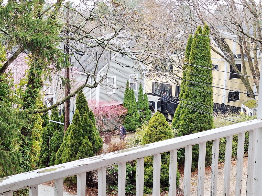 18 Bennett Street, Unit 2 Manchester, MA 01944 - Photo 8 of 21 a view of a white house next to a yard