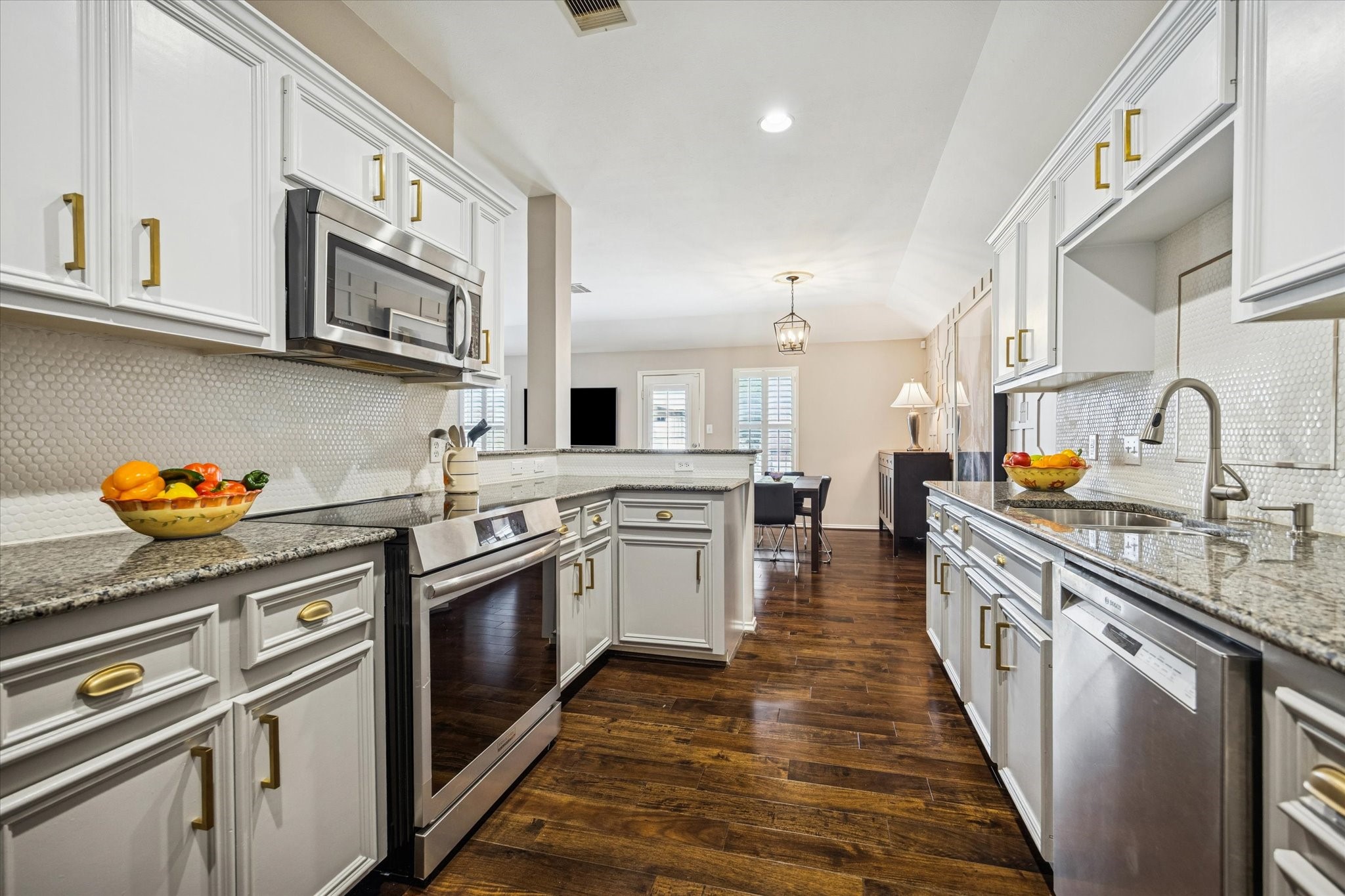 1810 Gillette Street Houston, TX 77019 - Photo 14 of 25 a kitchen with stainless steel appliances granite countertop lots of counter top space and wooden floor