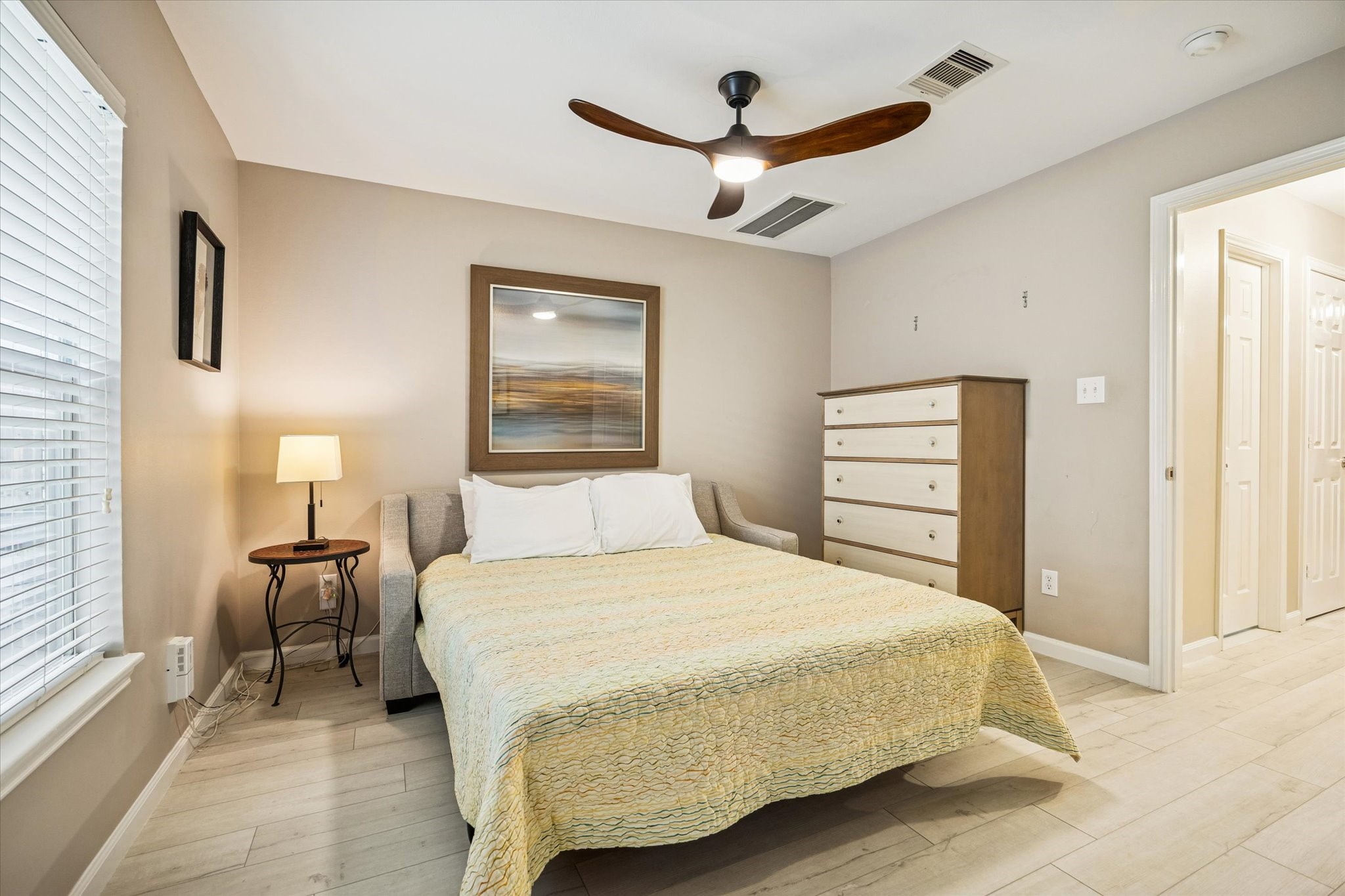 1810 Gillette Street Houston, TX 77019 - Photo 5 of 25 a bedroom with a bed and a chandelier