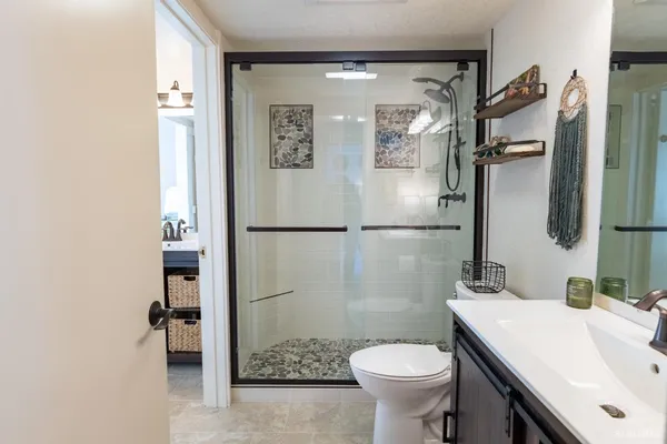 a bathroom with a sink toilet and shower