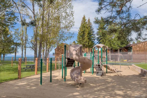a view of a park with iron fence