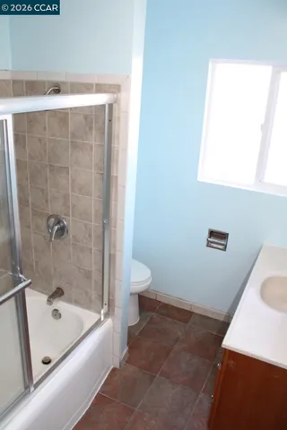 a bathroom with a tub a sink and a toilet