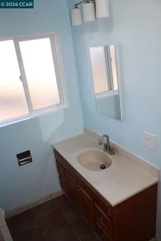 a bathroom with a sink a vanity and a window