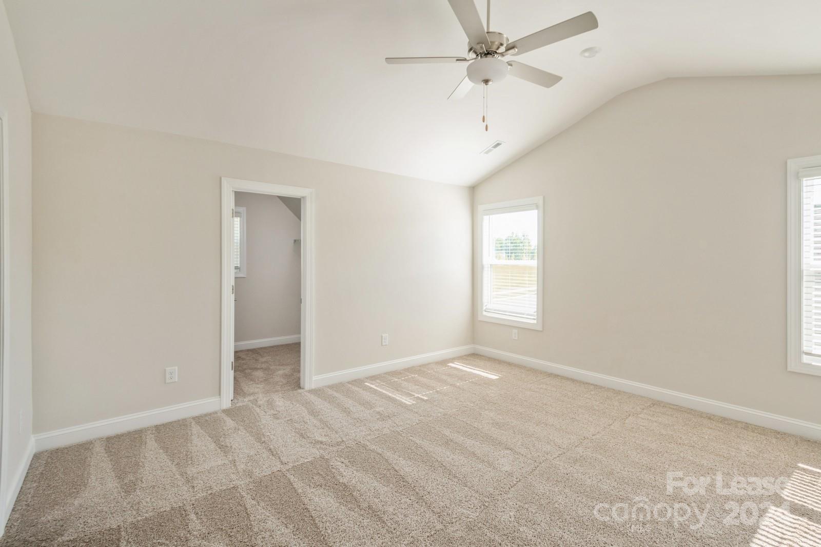 211 Adams Tree Way Troutman, NC 28166 - Photo 13 of 32 an empty room with fan and windows