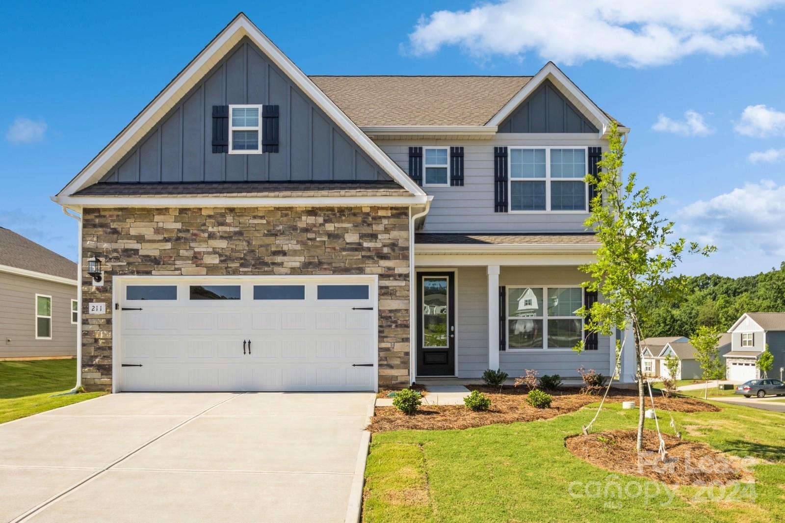 211 Adams Tree Way Troutman, NC 28166 - Photo 2 of 32 a front view of a house with a yard