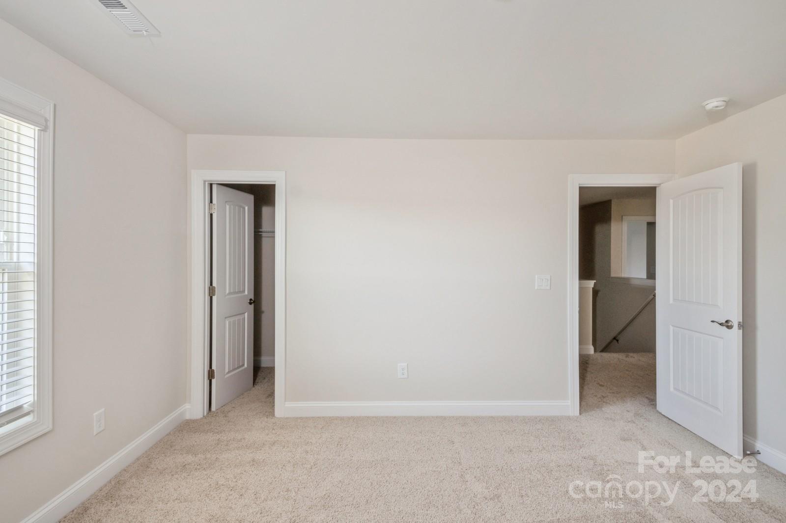 211 Adams Tree Way Troutman, NC 28166 - Photo 21 of 32 an empty room with closet and a window