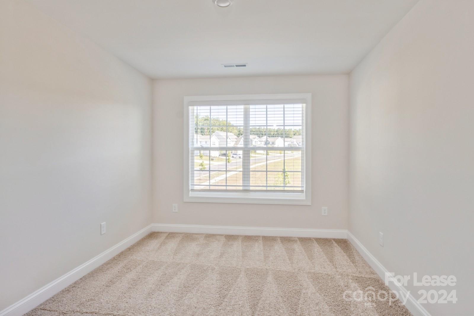 211 Adams Tree Way Troutman, NC 28166 - Photo 22 of 32 an empty room with a window