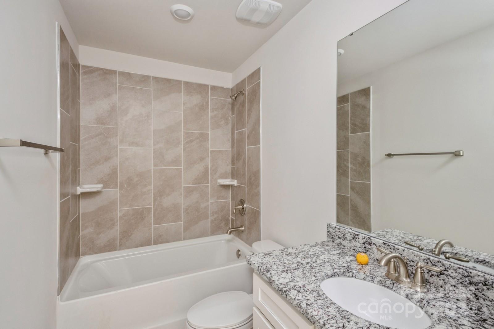 211 Adams Tree Way Troutman, NC 28166 - Photo 24 of 32 a bathroom with a granite countertop sink toilet and shower