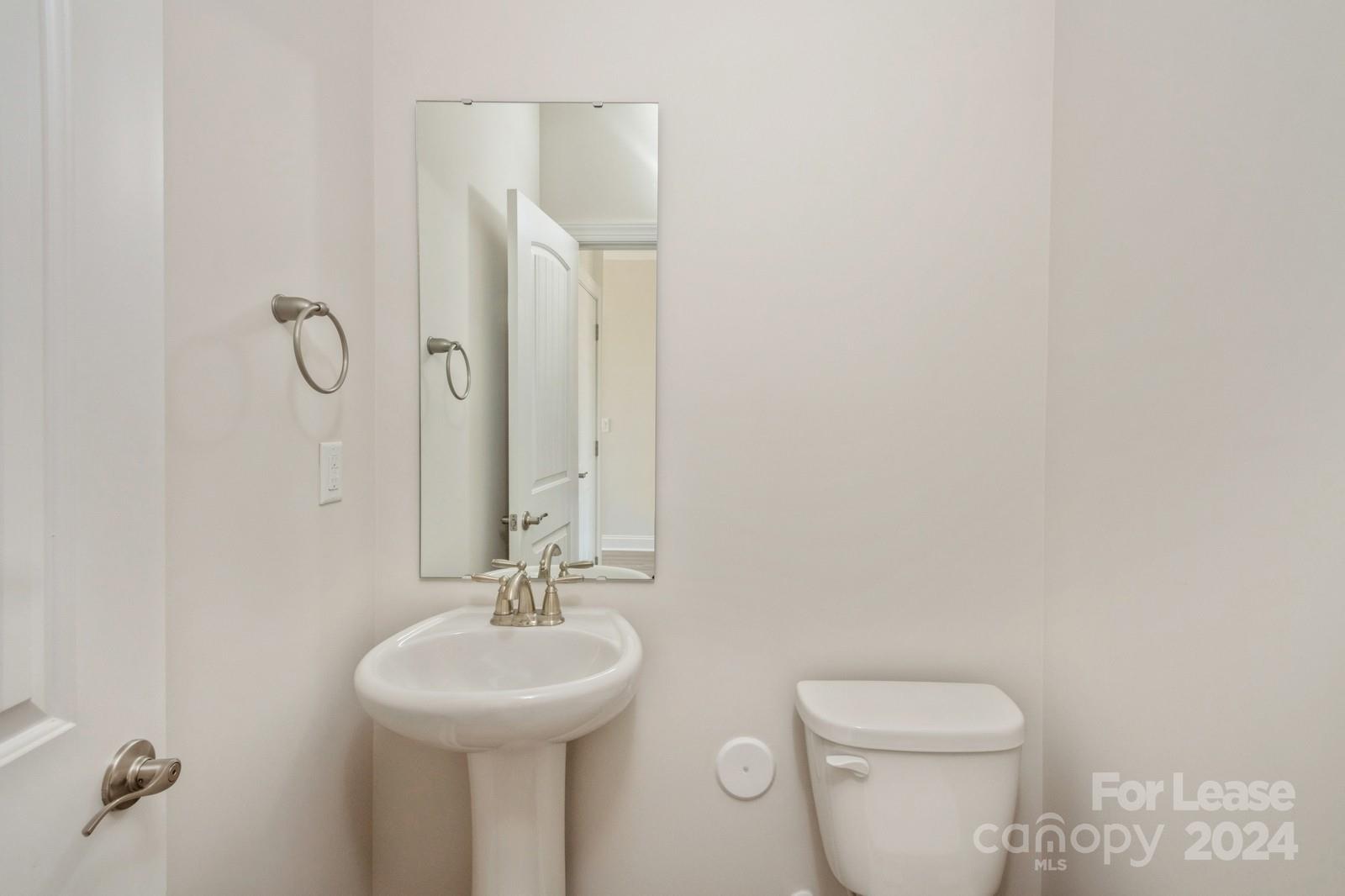 211 Adams Tree Way Troutman, NC 28166 - Photo 26 of 32 a bathroom with a sink a toilet and a mirror