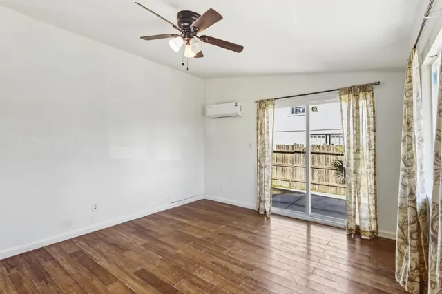 wooden floor in an empty room with a window