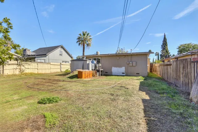 a view of a house with backyard and swimming pool