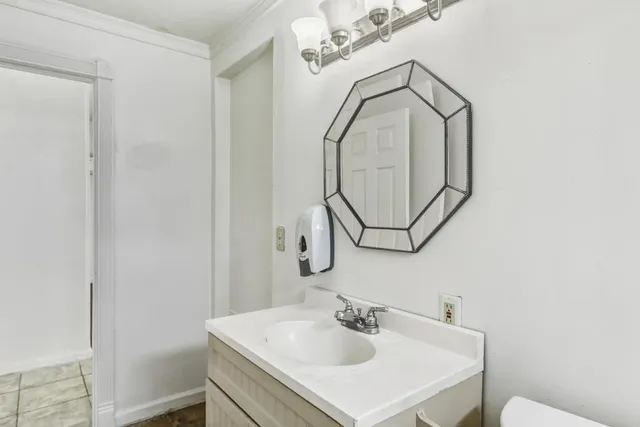 a bathroom with a sink vanity and a mirror