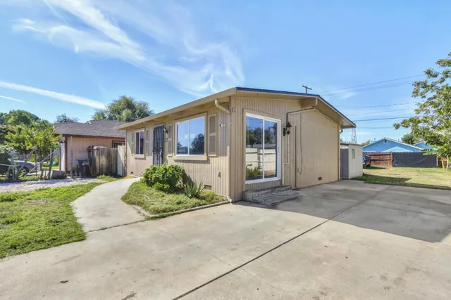 a front view of a house with a garden