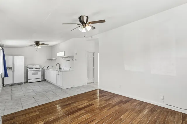 a view of a kitchen with wooden floor