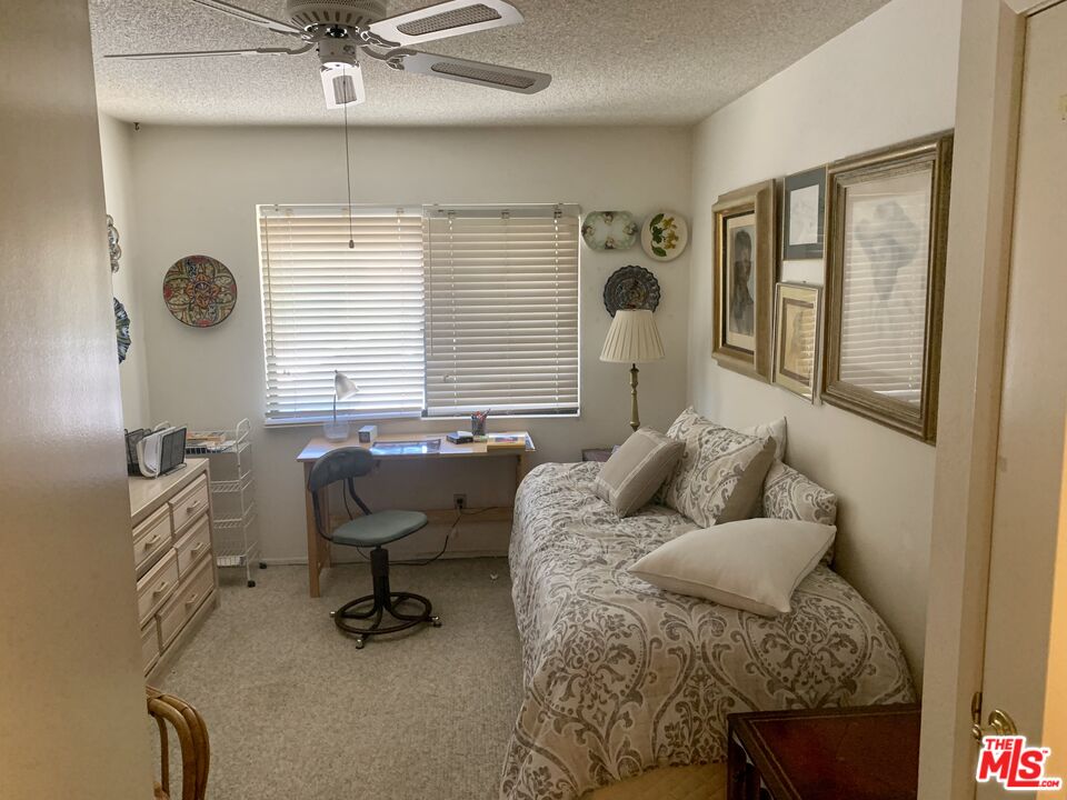 7312 Corbin Avenue, Unit M Reseda, CA 91335 - Photo 11 of 18 a living room with furniture and a window