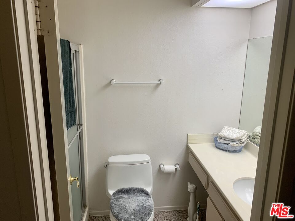 7312 Corbin Avenue, Unit M Reseda, CA 91335 - Photo 12 of 18 a bathroom with a sink a toilet a mirror and vanity