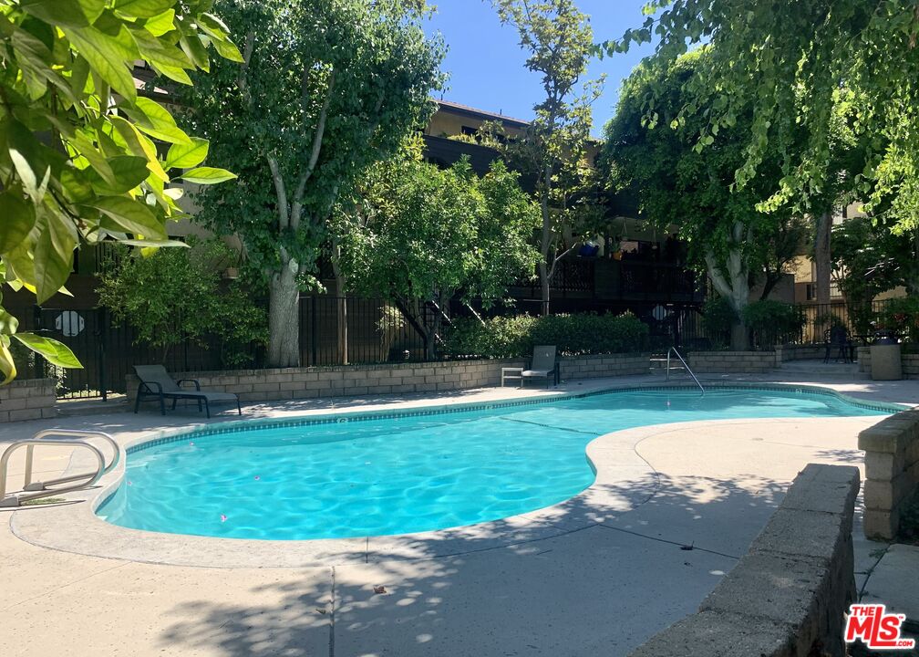 7312 Corbin Avenue, Unit M Reseda, CA 91335 - Photo 15 of 18 a view of a swimming pool with a patio