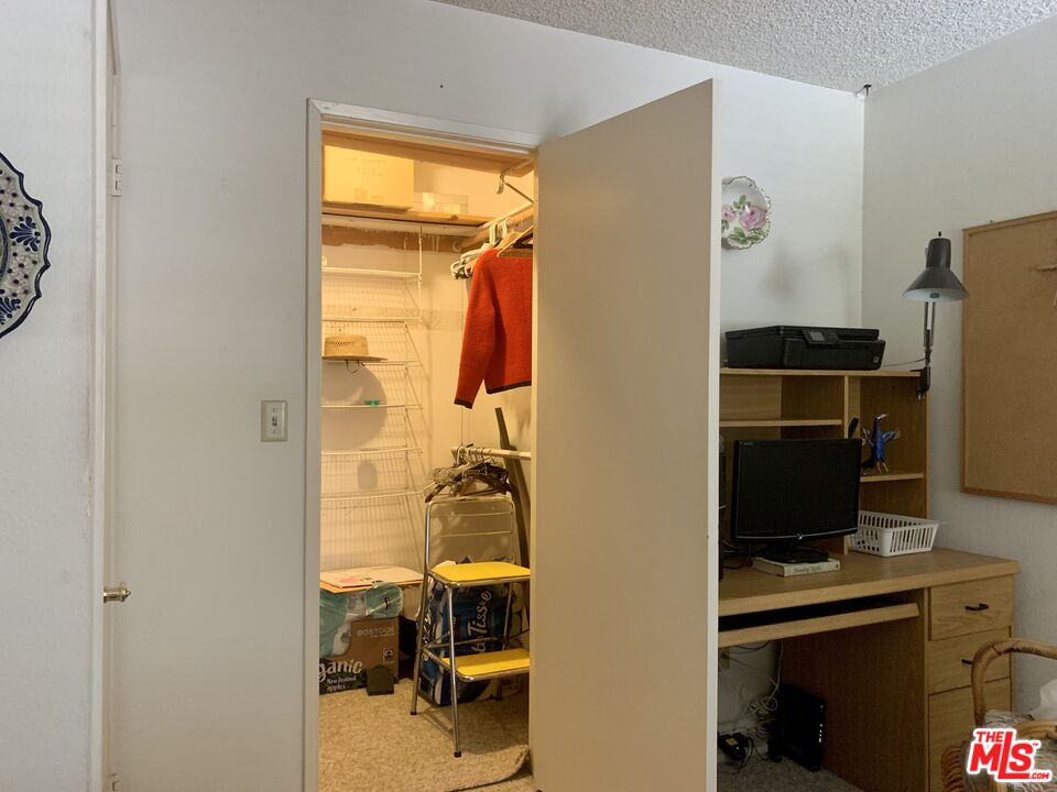 7312 Corbin Avenue, Unit M Reseda, CA 91335 - Photo 10 of 18 a view of walk in closet with clothes and shoes
