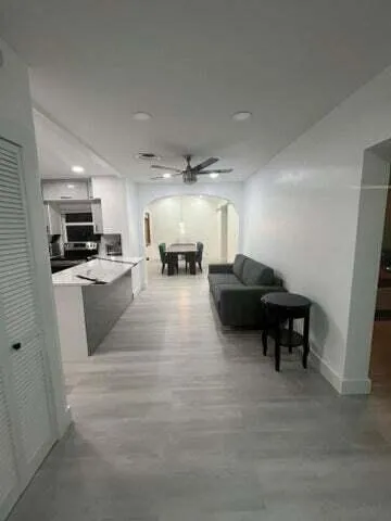 a living room with furniture and kitchen view