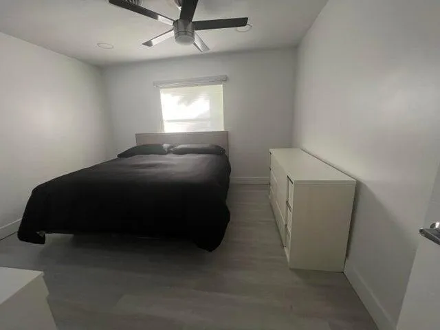 a bedroom with a bed and a window