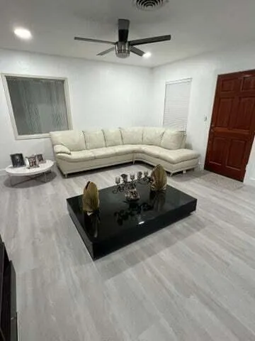 a living room with furniture rug and window
