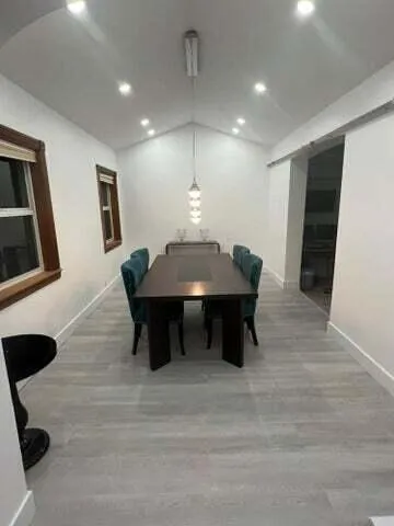 a dining room with furniture and window