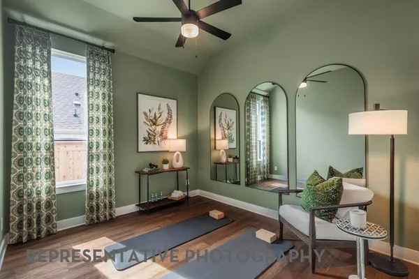 a living room with furniture and two window